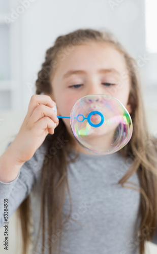 Photo: Girl blowing bubbles Girl blowing bubbles
