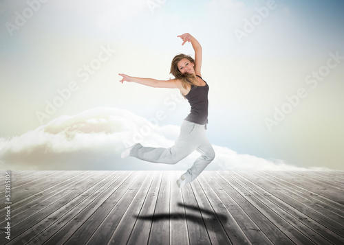 Photo: Woman jumping over wooden boards Woman jumping over wooden boards