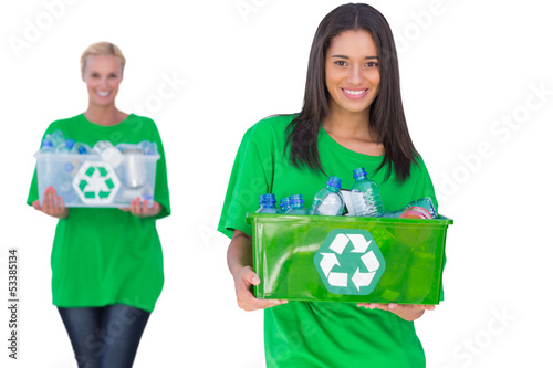 Photo: Two enivromental activists holding box of recyclables Two enivromental activists holding box of recyclables