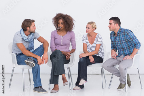 Photo: Stylish people sitting and chatting Stylish people sitting and chatting