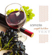 glass of red wine with bottle and grapes