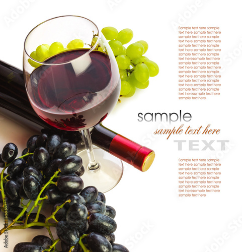 Photo: glass of red wine with bottle and grapes glass of red wine with bottle and grapes