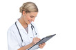 Smiling nurse writing on clipboard