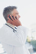 Attractive doctor phoning