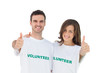 Two young volunteers giving thumbs up