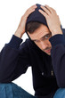 Worried man with head in hands