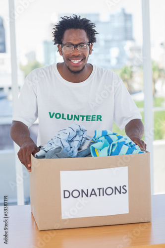 Photo: Happy man holding donation box Happy man holding donation box