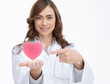 Foto: Doctor holding and pointing at a pink heart Doctor holding and pointing at a pink heart