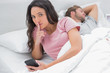Woman doing a quiet sign while text messaging