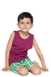Photo: Smiling young boy sits on the floor Smiling young boy sits on the floor