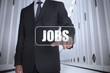 Businessman in a data center selecting label with jobs