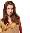 Young woman holding a grocery bag full of bread