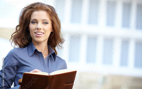 Photo: Young happy women or student on the property business background Young happy women or student on the property business background