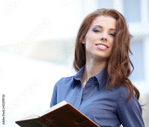 Photo: Young happy women or student on the property business background Young happy women or student on the property business background