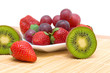 juicy ripe berries and fruit - kiwi, strawberries and grapes.