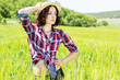 Photo: Beautiful woman in hat on summer meadow Beautiful woman in hat on summer meadow
