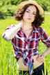 Photo: Beautiful woman in hat on summer meadow Beautiful woman in hat on summer meadow