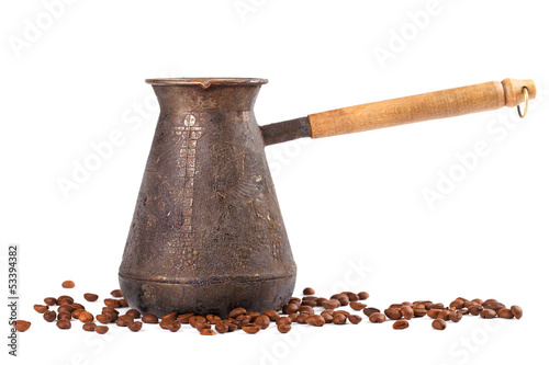 Photo: Old coffee pot with coffee beans. Isolated on white Old coffee pot with coffee beans. Isolated on white