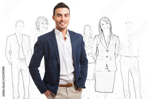 Photo: Smiling man in front of a group of sketched people Smiling man in front of a group of sketched people