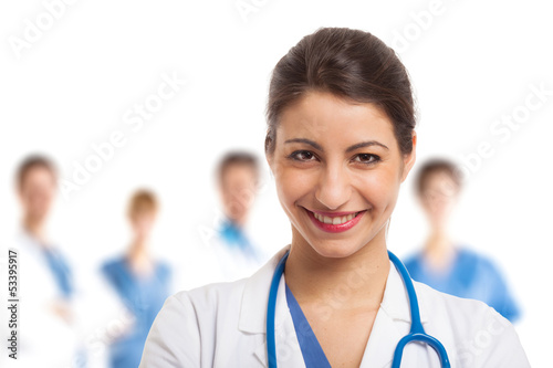 Photo: Smiling nurse in front of her team Smiling nurse in front of her team