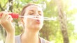 Girl blowing soap bubbles