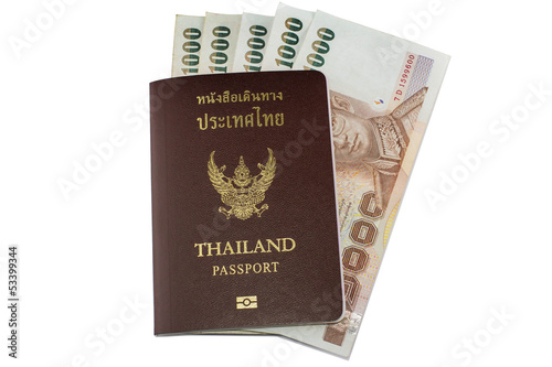 Photo: Thailand passport and Thai money on white background Thailand passport and Thai money on white background