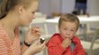 Mom feeds her son in restaurant