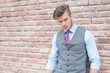 casual man by brick wall closeup