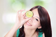 Photo: woman holding kiwi fruit cover her eyes woman holding kiwi fruit cover her eyes