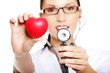 Photo: Young female doctor with heart in her hand. Young female doctor with heart in her hand.