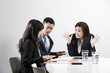 Chinese business team shouting at each other in business meeting