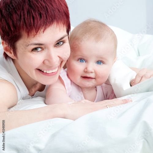 Photo: Mother and baby in the bed Mother and baby in the bed