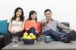 Happy Chinese friends hanging out together at home