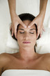 Young woman getting a facial massage