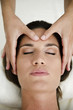 Young woman getting a facial massage
