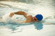 Young man in health club swimming pool