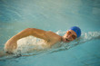 Young man in health club swimming pool