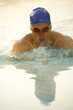 Young man in health club swimming pool