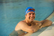 Young man in health club swimming pool