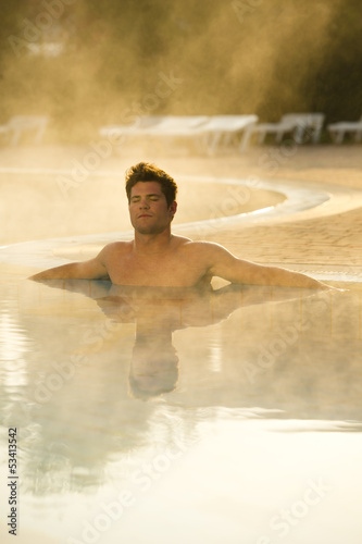 Photo: Young man in health club swimming pool Young man in health club swimming pool