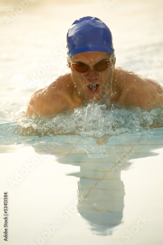 Photo: Young man in health club swimming pool Young man in health club swimming pool