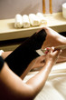 Young woman getting a mud treatment on leg