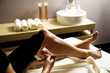 Young woman getting a mud treatment on leg