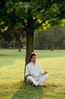Young man meditating under a tree