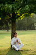 Young man meditating under a tree