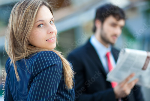 Photo: Two businesspeople in an urban setting Two businesspeople in an urban setting