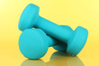 Dumbbells on yellow background