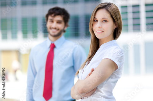 Photo: Two businesspeople in an urban setting Two businesspeople in an urban setting