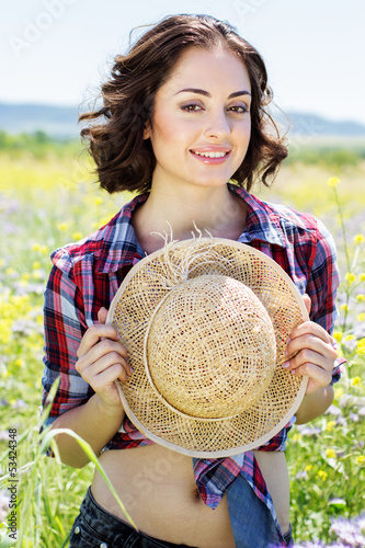 Photo: Portrait of young woman in the flowers field Portrait of young woman in the flowers field