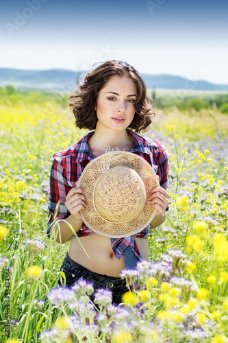 Photo: Portrait of young woman in the flowers field Portrait of young woman in the flowers field